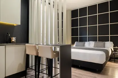 a bedroom with a bed and a table and chairs at The Valentia Cabillers in Valencia
