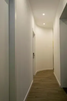 an empty hallway with white walls and a door at Hotel El Siglo in Valencia