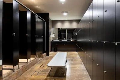 a bench in a locker room with a sink at Parador de El Saler in El Saler