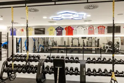 a gym with rows of dumbbells on display at Parador de El Saler in El Saler