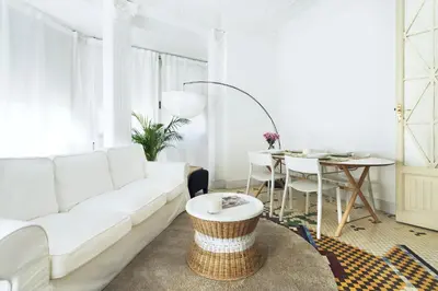 a living room with a white couch and a table at Victoria Site-Luxury Center in Valencia