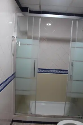 a glass shower in a bathroom with a toilet at La Posá in Villar del Arzobispo
