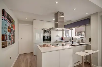 a kitchen and living room with a counter top with a stove at Beds & Breaks Casals in Valencia