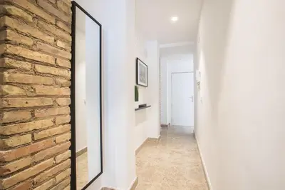 a mirror leaning against a brick wall in a hallway at Apartamentos Marina Playa in Valencia
