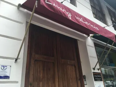 a sign on a building with a wooden door at Living Valencia Peydro in Valencia