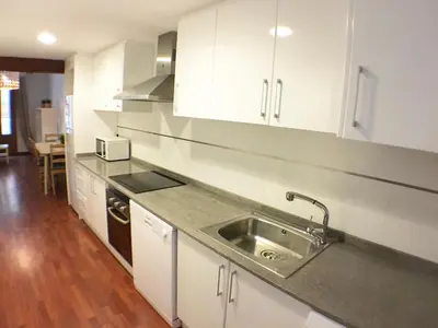 a kitchen with white cabinets and a sink at Living Valencia Peydro in Valencia
