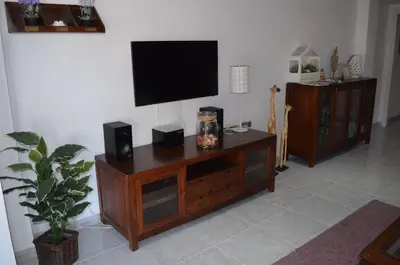 a entertainment center with a flat screen tv on a wall at Sweet Caroline Apartment in Valencia