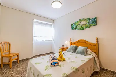 a bedroom with a bed with a stuffed animal on it at MoYma Playa in Puerto de Sagunto