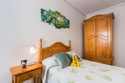 a bedroom with a bed with a yellow toy on it at MoYma Playa in Puerto de Sagunto