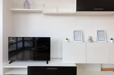 a living room with a tv and white cabinets at Travel Habitat Torres de Serrano in Valencia