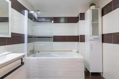 a white bathroom with a tub and a sink at Travel Habitat Torres de Serrano in Valencia