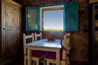 a table and chairs in a room with a window at Villa Rotonda in Alquerías del Niño Perdido