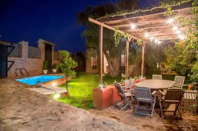 a patio with a table and chairs and a pool at Villa Rotonda in Alquerías del Niño Perdido