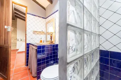 a blue tiled bathroom with a toilet and a sink at Villa Lupita in Alquerías del Niño Perdido