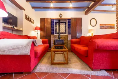 a living room with two red couches and a tv at Villa Lupita in Alquerías del Niño Perdido