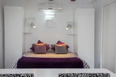 a bedroom with a bed with purple sheets and pillows at Apartment Boutique in Valencia