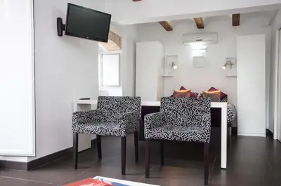 a room with a table and two chairs and a tv at Apartment Boutique in Valencia