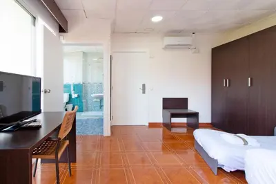 a bedroom with a bed and a desk and a television at Hotel Sagunto in Sagunto