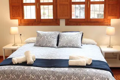 a bedroom with a bed with two towels on it at Apartamento Torres in Valencia