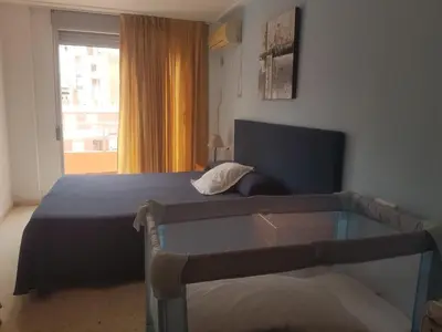 a bedroom with a bed and a glass table at Hotel L'Escala in Cullera