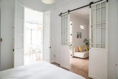 a bedroom with a door leading to a living room at ABCyou Bed&Breakfast in Valencia