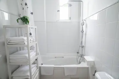 a white bathroom with a bath tub and a sink at ABCyou Bed&Breakfast in Valencia