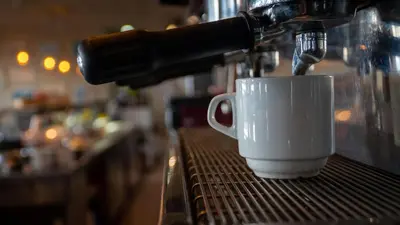 a coffee maker is making a cup of coffee at Hotel Puerta de la Serrania in Lliria