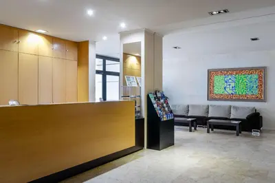 a waiting room with a counter and a couch in a room at Aparthotel Wellness in Paterna
