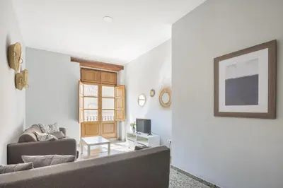 a living room with a couch and a tv at Macflats Valencia Puerto in Valencia