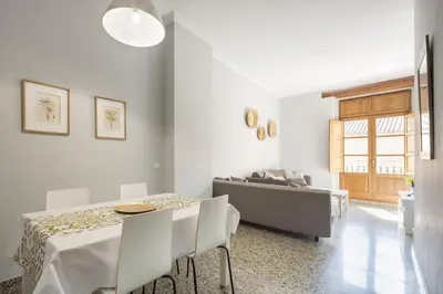 a white living room with a table and a couch at Macflats Valencia Puerto in Valencia