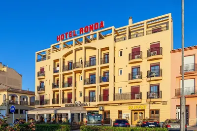 a large yellow building with a sign on it at Hotel Olympia Ronda I in El Puig