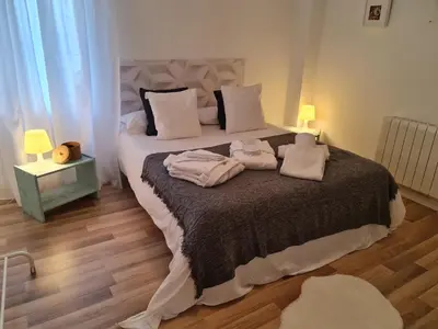 a bedroom with a large bed with towels on it at Alojamientos Segóbriga Rural (Artesa) in Segorbe