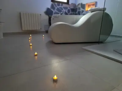 a living room with candles on the floor at Alojamientos Segóbriga Rural (Artesa) in Segorbe