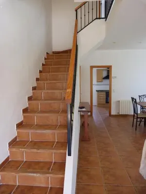 a staircase in a house with a wooden floor at Adosado Calle Mar Cantabrico in Puebla de Vallbona