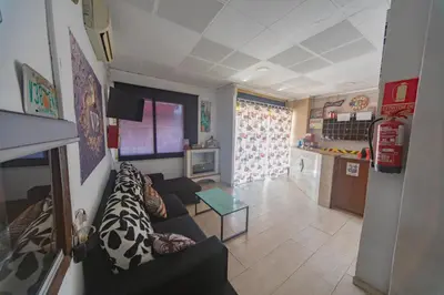a living room with a couch and a table at Hostal Virginia in Favareta
