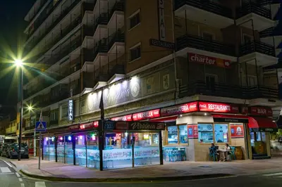 a building on a city street at night at Hostal Virginia in Favareta