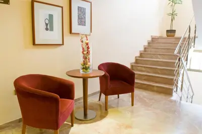 two chairs and a table in a room with stairs at Torrijos in Cheste