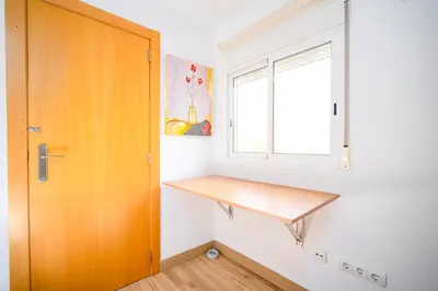 a room with a wooden shelf next to a window at Ático de Lujo Plaza Ayuntamiento in Valencia