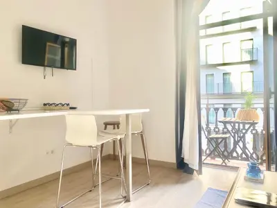 a white table and chairs in a room with a balcony at Victoria Site-Mercat Central in Valencia