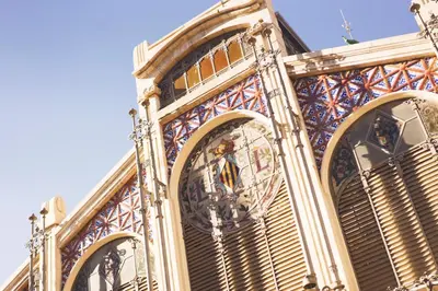a building with a clock on the side of it at Victoria Site-Mercat Central in Valencia