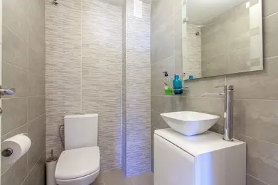 a bathroom with a toilet and a sink and a shower at Apartment Malvarrosa Beach Cavite in Valencia