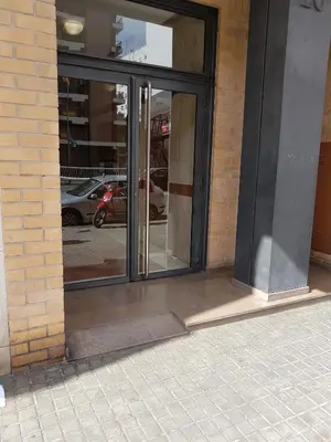 an entrance to a building with glass doors at Pasarela Apartment in Valencia