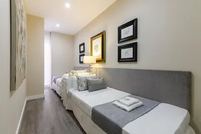 a bedroom with three beds in a room at MD Pelayo in Valencia