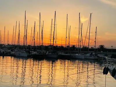 a group of boats docked in a marina at sunset at Apartment on Carrer del Dr. Lluch in Valencia