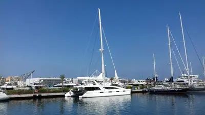 a white boat docked in a marina with other boats at Apartment on Carrer del Dr. Lluch in Valencia