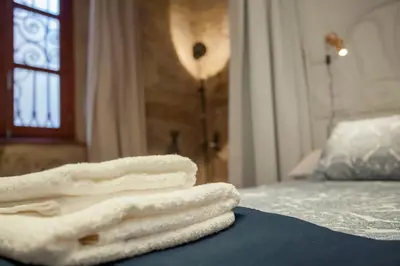 a pile of towels sitting on top of a bed at Apartamento Horno in Valencia