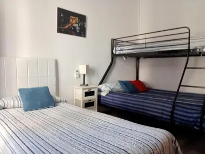 two beds in a room with two bunk beds at Lola Apartment Encorts in Valencia