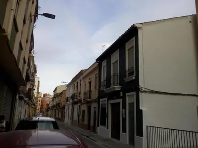 a car is parked on a street with buildings at Lola Apartment Encorts in Valencia