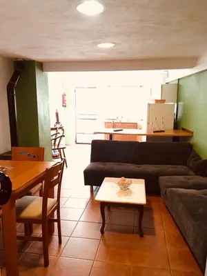 a living room with a couch and a table at La casita Santa Bárbara in Macastre