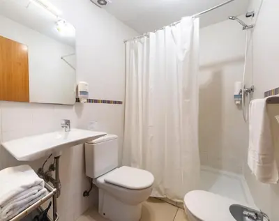 a bathroom with a toilet and a sink and a shower at Quart Silence in Valencia